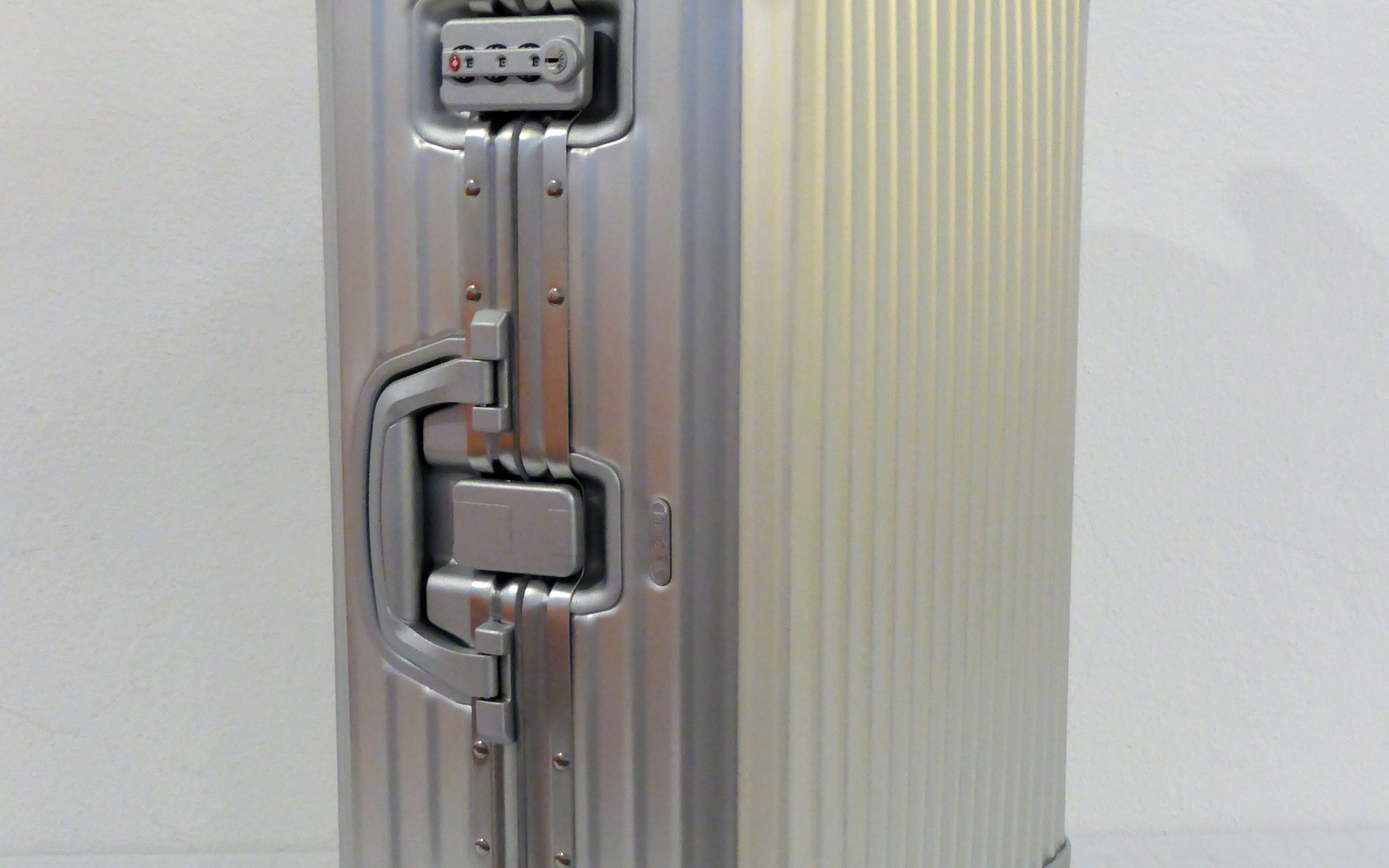 Editorial illustration of three luxury carry-on suitcases