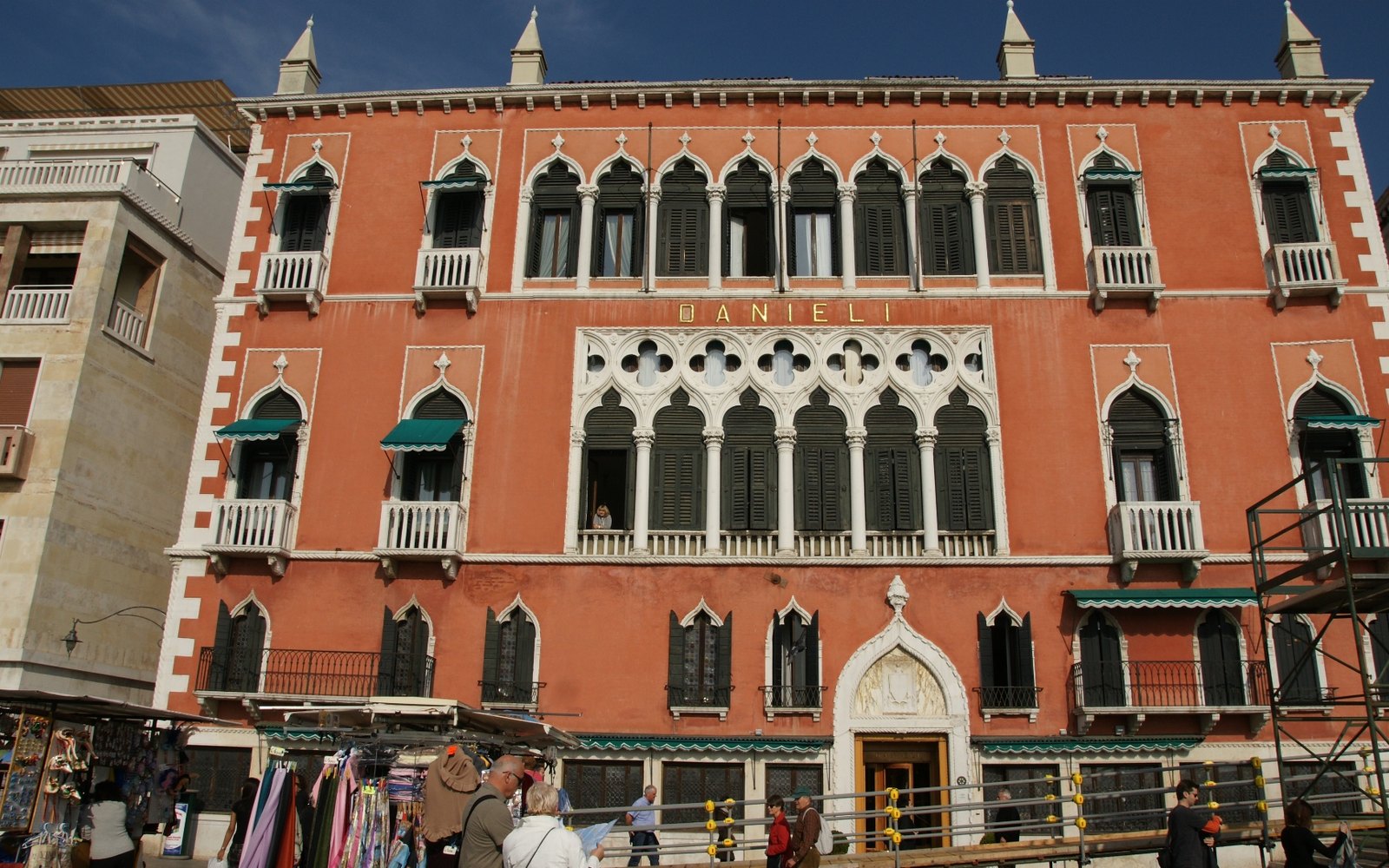 Editorial illustration of a grand Venetian hotel facade on the lagoon